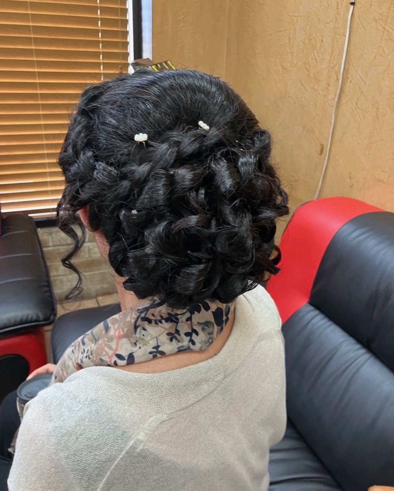 Romantic curled updo on dark hair pinned for a wedding