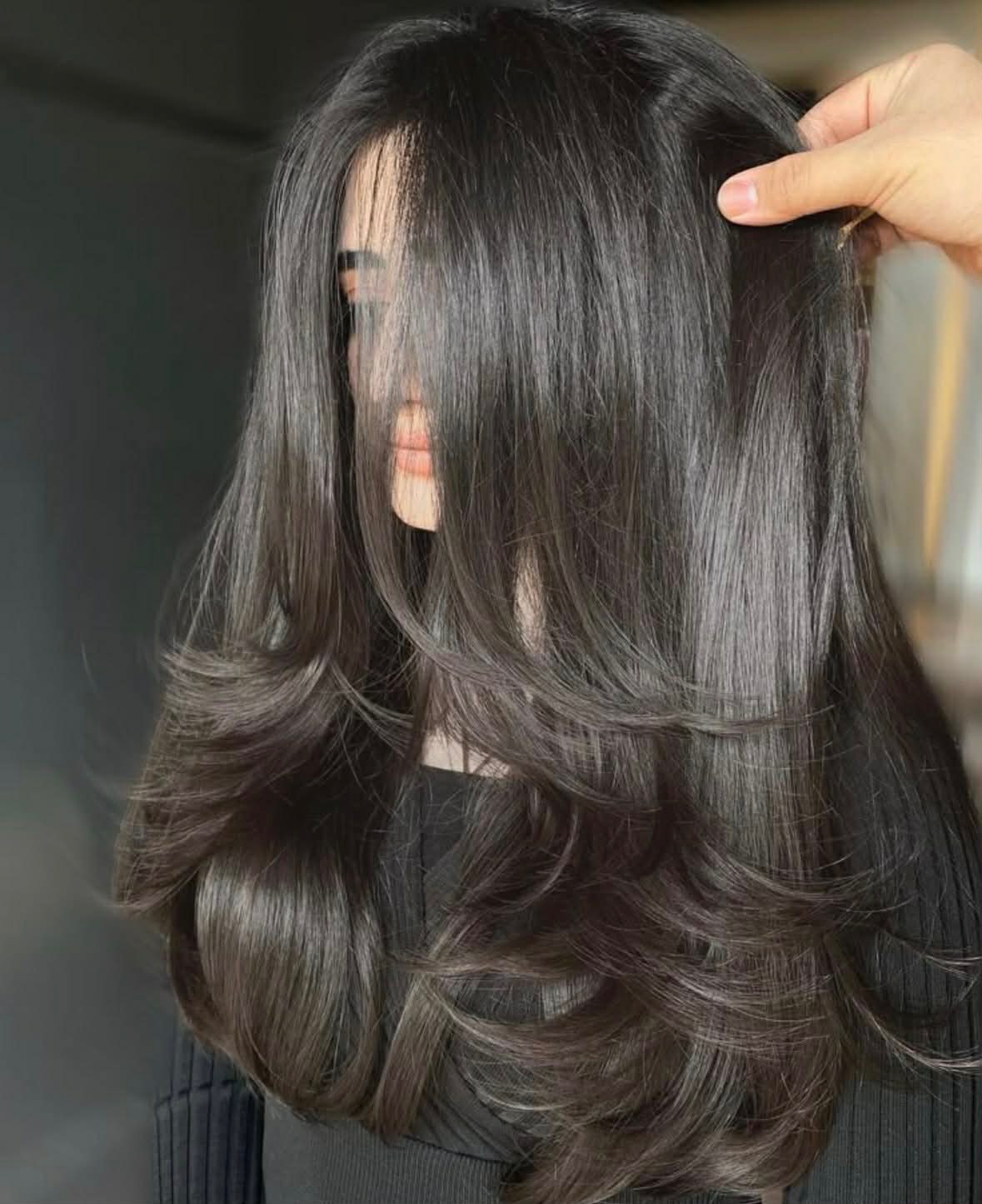 Glossy dark S-waves on mid-length hair after a cut and blow dry
