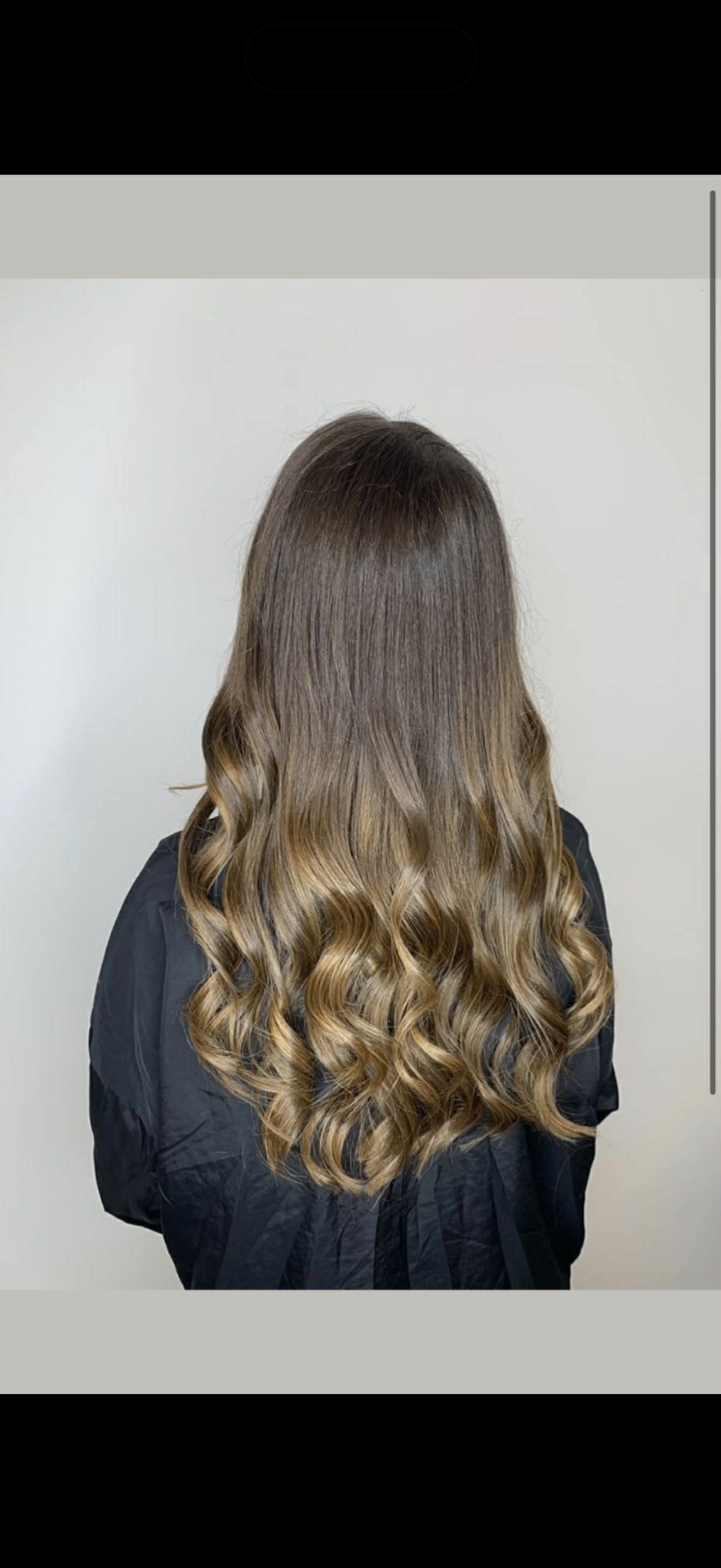 Dark hair with blonde ombre ends styled into defined spiral curls